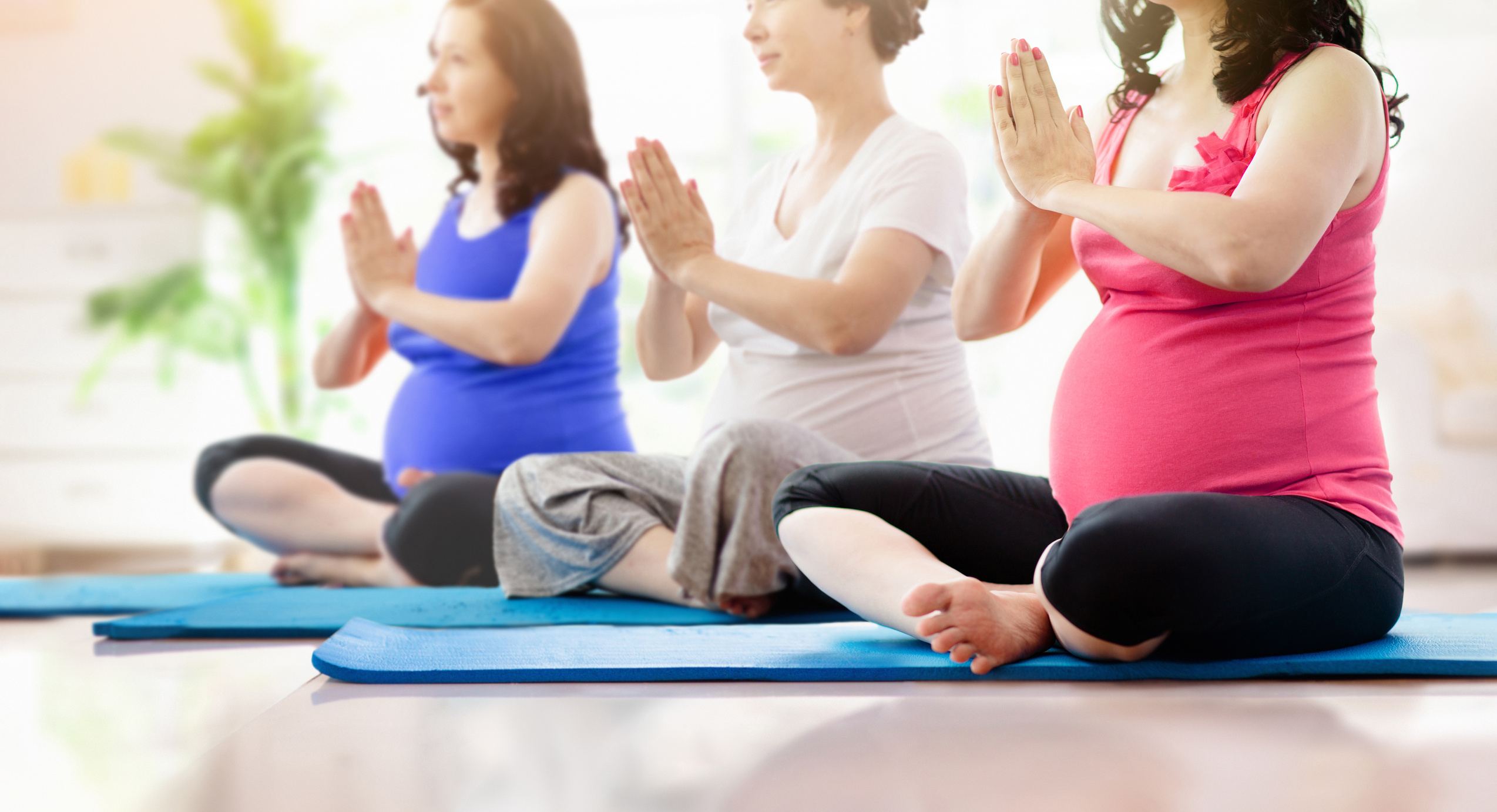 Pregnant Women Doing Yoga Indoors